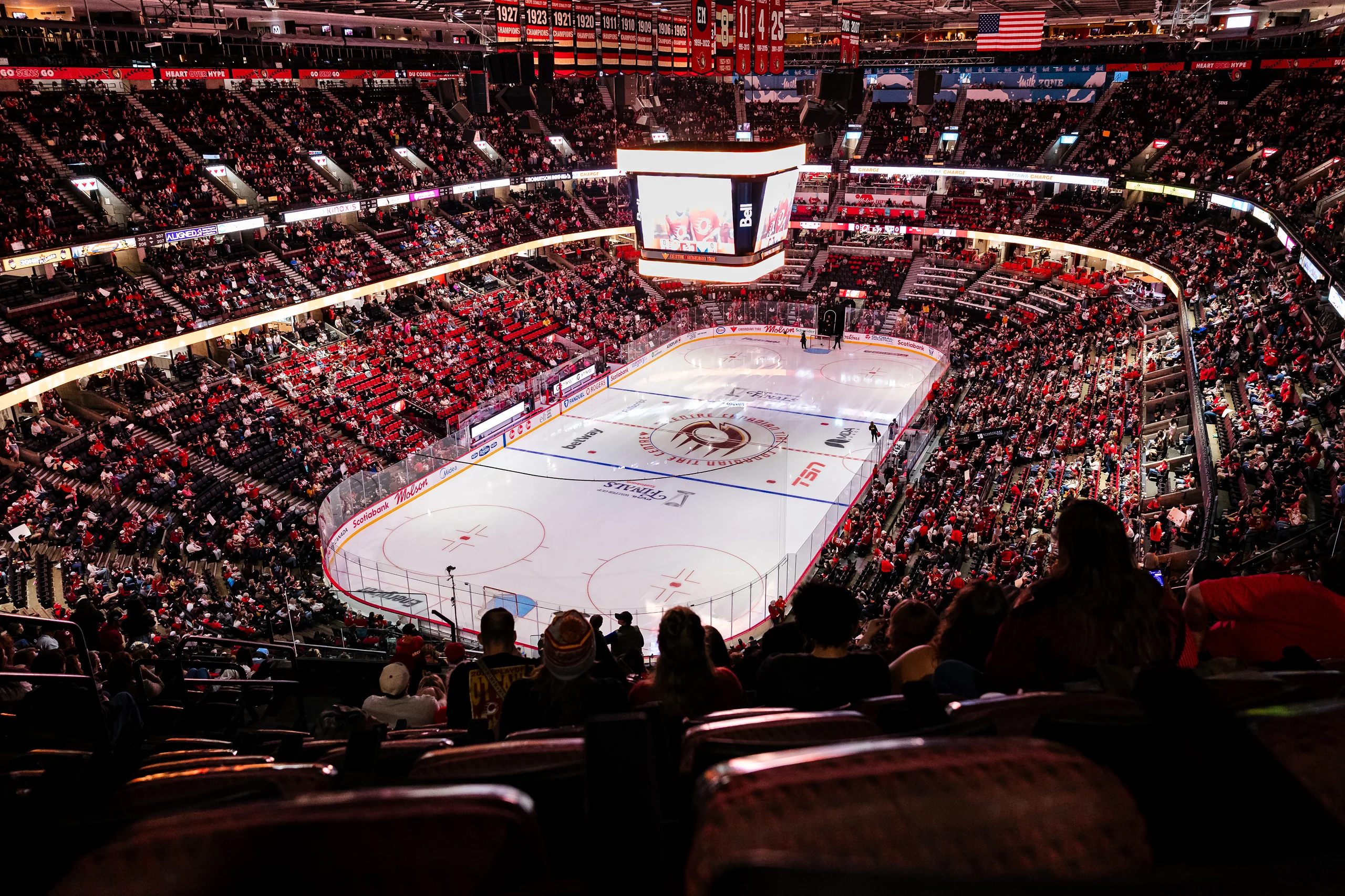 A Montréal arena filling up before a game, seen from the upper bowl above the rink.
